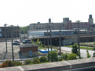 large abandoned factory seen from nearby roof