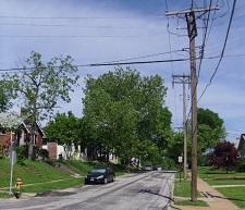 ordinary attractive bungalows share the assets of electrical power, fire hydrant, paved street nice bungalows in ordinary residential neighborhood