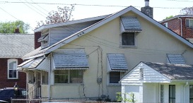 brick home, frame home, and multi-family home in background show considerably different design characteristics