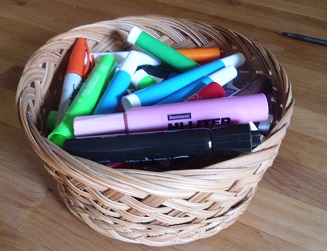 colored markers in a basket