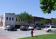 row of storefronts in smaller city with parking area in front row of storefronts in smaller city with parking area in front