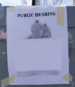 Public Hearing Flyer black-and-white flyer for a public hearing taped to utility box