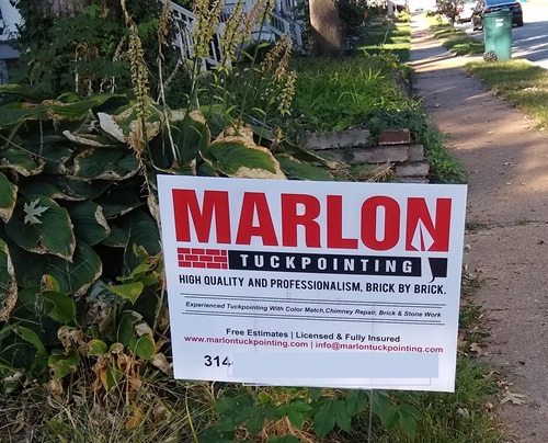 sign advertising contractor working on a home sign advertising contractor working on a home