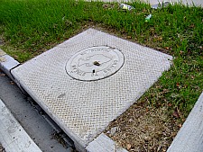 storm drain cover reminding people of environmental hazard of putting chemicals down drains