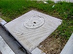storm drain cover reminding people not to dispose of pollutants there