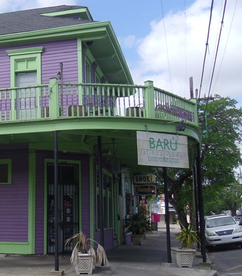 hanging sign on corner above colorful restaurant entrance hanging sign on corner above colorful restaurant entrance