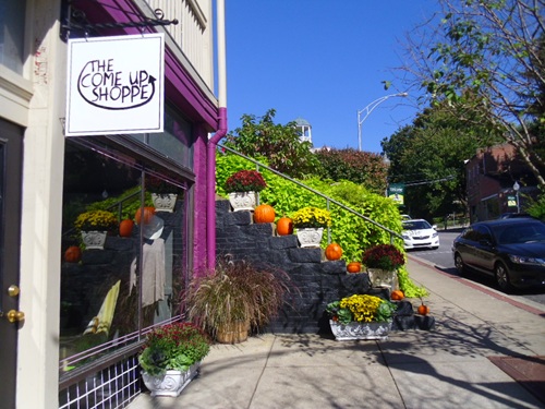 upstairs shop sign is both hanging and projecting upstairs shop sign is both hanging and projecting