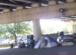 homeless tents and blankets under bridge viaduct