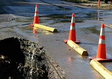 deep hole in street indicates a land cave-in rather than simply a pavement failure deep hole in street several feet in diameter