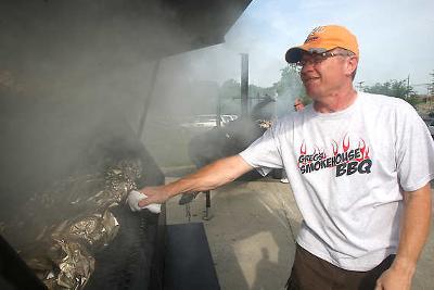Greg Morris works on his booth smoking various meats at the 2010 BBQ at the Quarry. Times Mail Photo/ Garet Cobb 2010