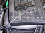 dusty keyboard, computer tower and screwdriver
