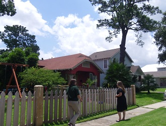 neighbors visiting on sidewalk in front of two homes neighbors visiting on sidewalk in front of two homes