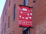 red sign projecting from brick building