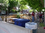 pop-up parklet shows parking space converted to picnic tables and performance space for musicians