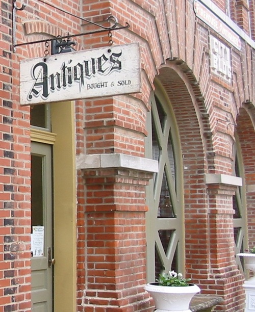 hanging sign on short chain projecting from building hanging sign on short chain projecting from building