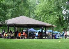 community improvement event fills pavilion and tents with volunteers park shelter full of people participating in community event