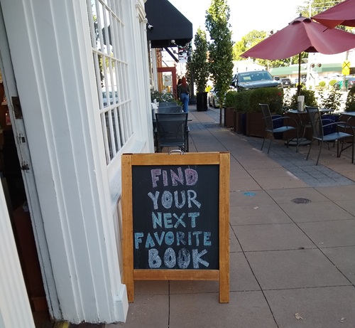 sandwich board in front of a bookstore sandwich board in front of a bookstore