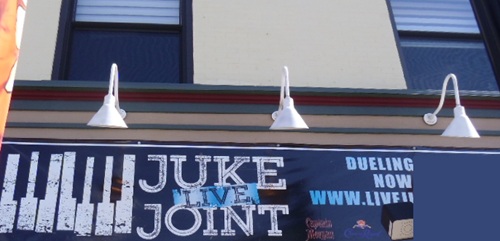 sign for piano bar with separate light fixtures above it sign for piano bar with separate light fixtures above it