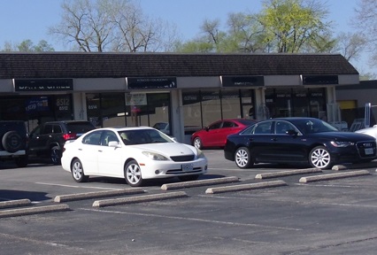highway oriented strip center with parking in front of retail establishments