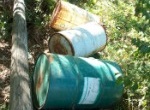 rusty drums near a creek