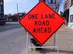 one lane road ahead sign